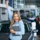 Young family choosing a car in a car showroom