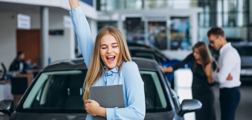 Young family choosing a car in a car showroom Young family choosing a car in a car showroom