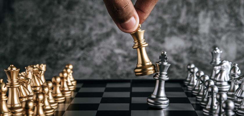 Hand of man playing chess for business planning and comparison o Hand of man playing chess for business planning and comparison of metaphor, selective focus