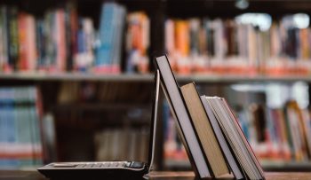 laptop computer and book on workplace in library room,Education laptop computer and book on workplace in library room,Education learning Concept